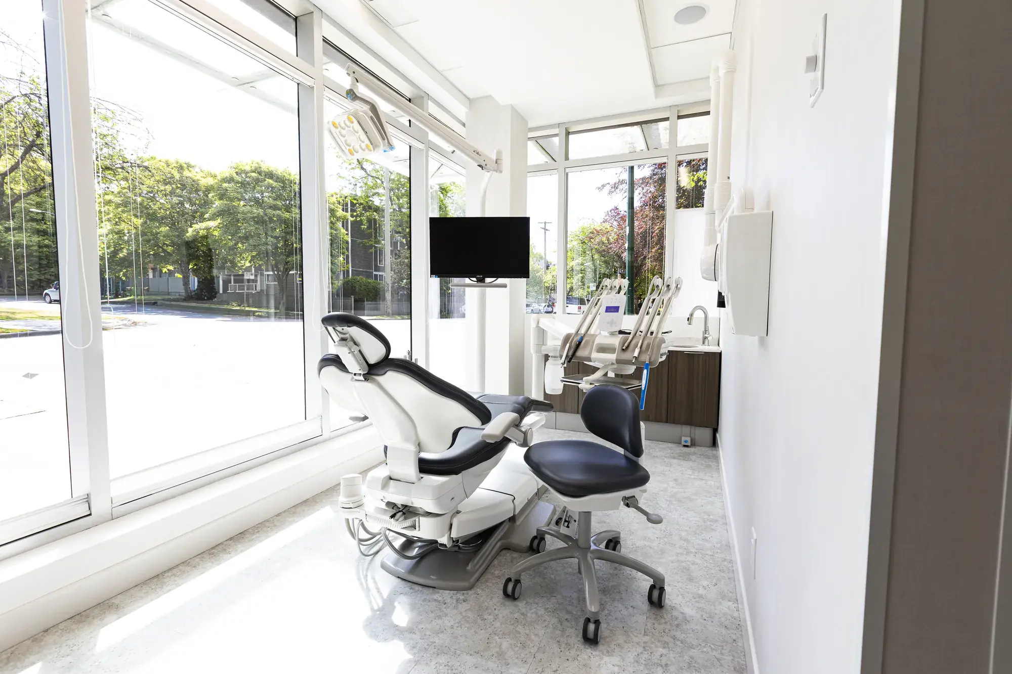 Bright dental treatment room with windows