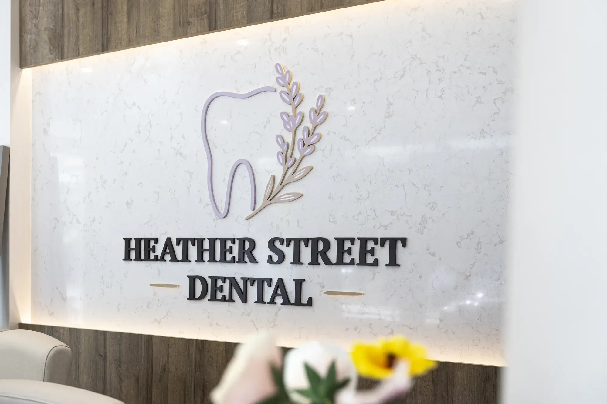 Heather Street Dental logo wall with flowers