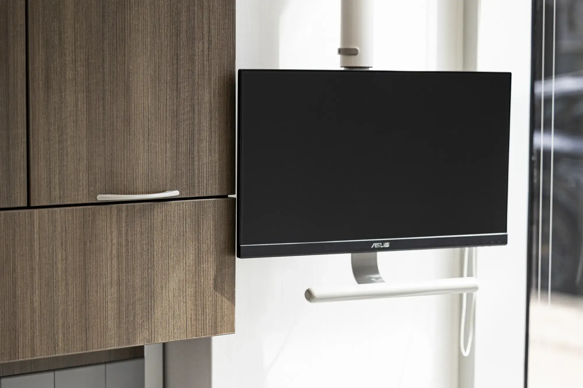 Clinical-room cabinetry and wall-mounted monitor