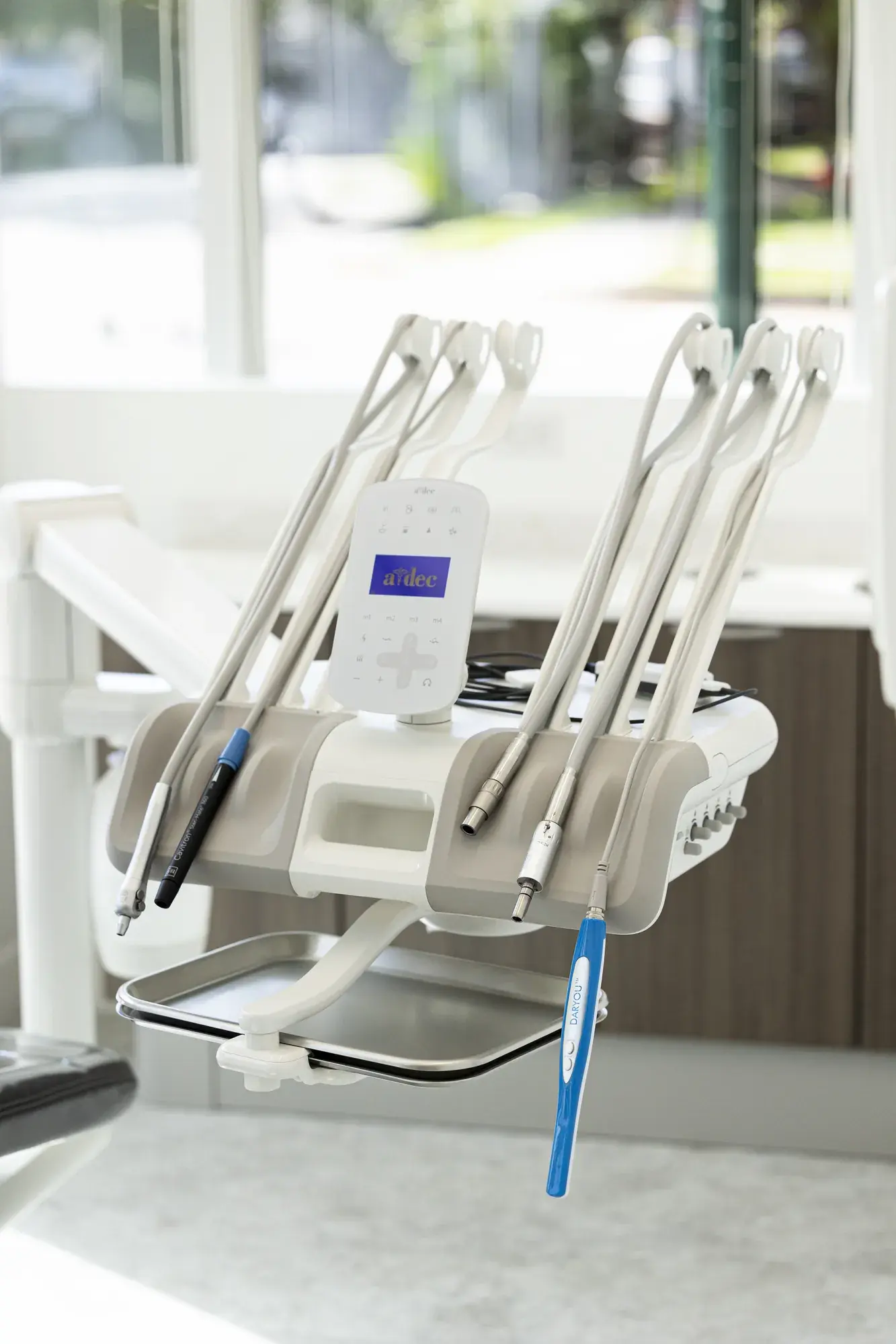 Dental chair and instruments beside a window