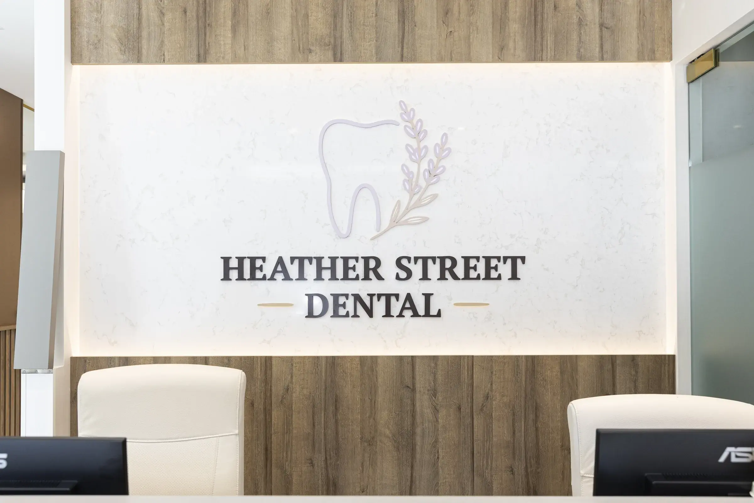 Heather Street Dental reception logo wall