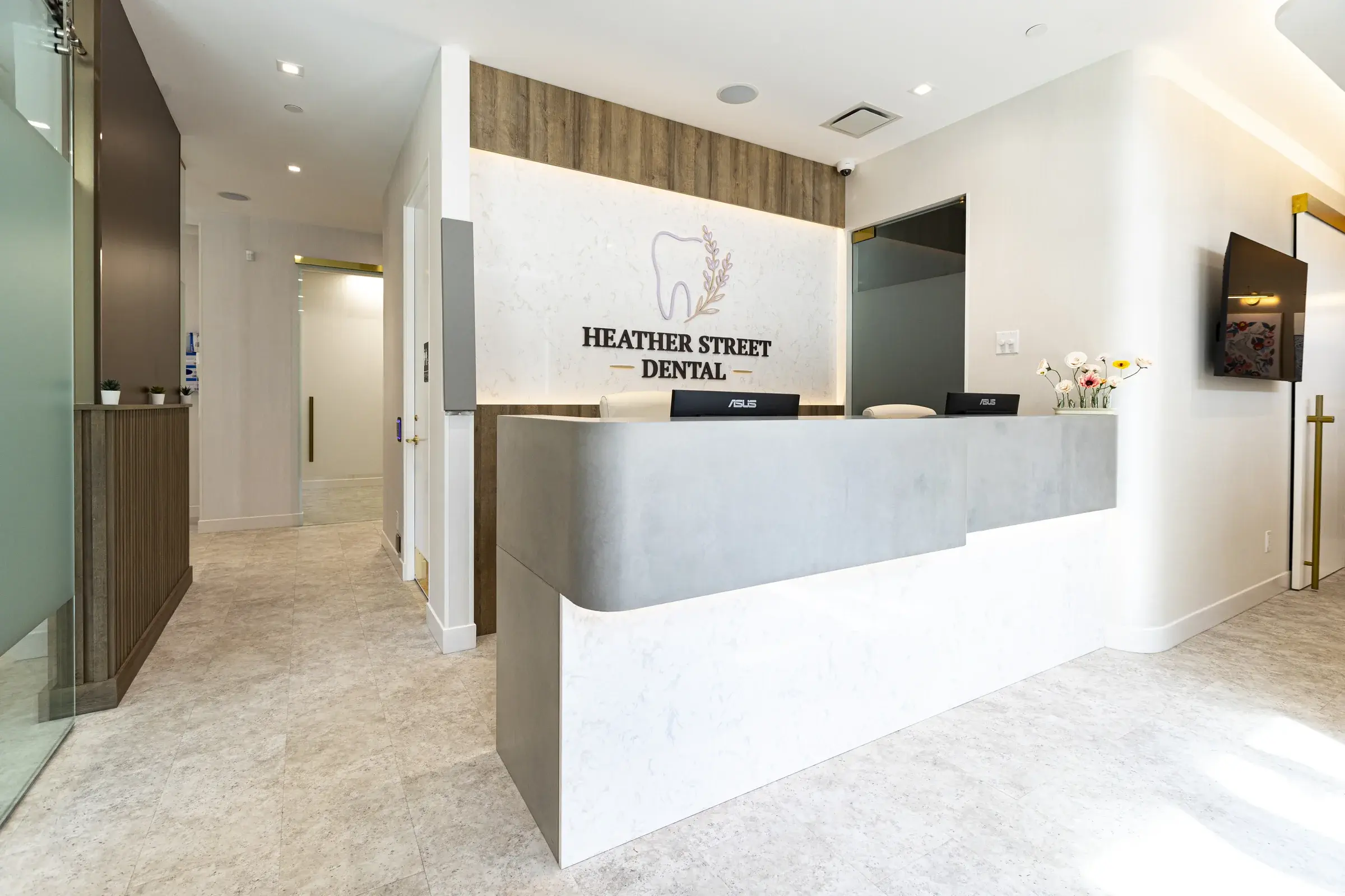 Heather Street Dental reception desk with the clinic logo on the wall